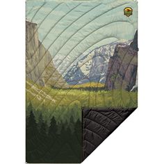 a blanket with mountains and trees in the background