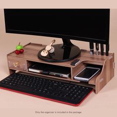 a computer desk with a keyboard, mouse and cell phone on it's stand