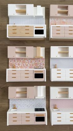 four models of kitchen furniture on a wooden table with white cabinets and pink wallpaper