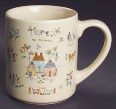 a coffee mug with farm scenes painted on it's side and inside the cup