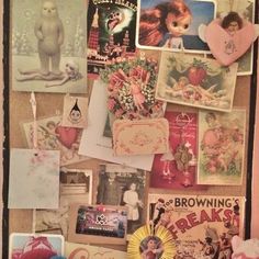 a wall covered in pictures and magnets on top of a wooden table next to a teddy bear