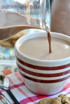 chocolate chip cookie being poured into a cup of coffee