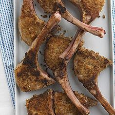 several pieces of meat on a plate with a blue and white napkin next to it