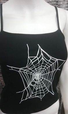 This is a black sleeveless Spiderwebs cropped tank top. This has a Spiderweb image screen printed on the front. 57% cotton/ 38% polyester/ 5% Spandex These are handmade screenprinted and slightly vary from the photo. Please feel free to email me any questions. Thanks for looking. Due to an influx of incorrect addresses if a package is returned, you must pay the shipping cost to resend the item to you. I do not do exchanges and I do not take returns unless the item is damaged. I thoroughly check Halloween Tank Tops, Black Stretch Crop Top For Halloween, Black Punk Crop Top For Cosplay, Edgy Black Crop Top For Halloween, Black Crop Top For Cosplay, Fitted Black Crop Top For Cosplay, Halloween Punk Black Crop Top, Black Halloween Crop Top For Streetwear, Black Punk Crop Top For Halloween