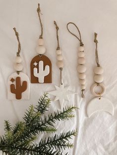 wooden ornaments are hanging on a white sheet