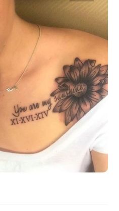 a woman with a sunflower tattoo on her chest that says, you are my sunshine