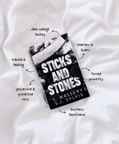 a book that is laying on top of a white sheet with the words sticks and stones written below it