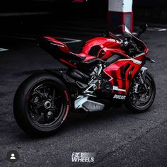 a red and black motorcycle parked on the street