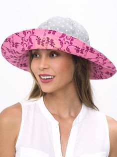 a woman wearing a pink and gray hat