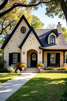 Charming cottage with arched doorway and cozy porch. The undeniable charm of cottage homes brings a rustic fairytale to life with each brick and beam.