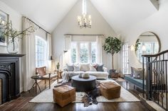 a living room filled with furniture and a fire place in the middle of a room