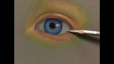 an eye being drawn with colored pencils