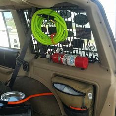 the inside of a car with an air hose and other items in the back seat