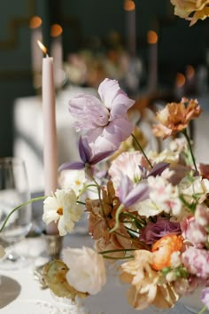 the table is set with flowers and candles for an elegant dinner party or special occasion