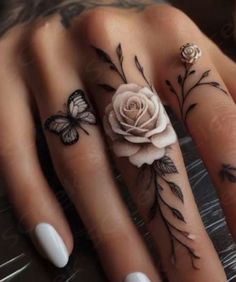 two fingers with tattoos and flowers on them