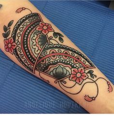 a woman's arm with an ornate tattoo design on the left side of her arm