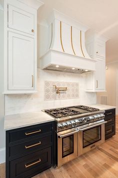 a stove top oven sitting inside of a kitchen next to white cabinets and wooden floors