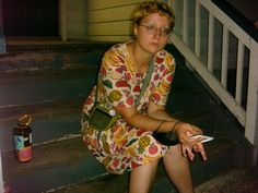 a woman sitting on the steps holding a cell phone