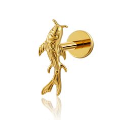 an image of a gold bird on a wall mounted coat or hat pin in the shape of a fish