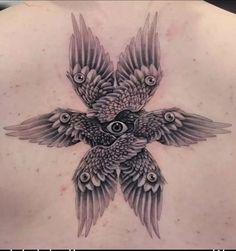 a woman's back with an owl tattoo on it