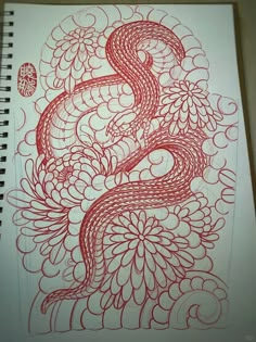 a drawing of a red snake on white paper