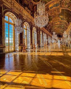 an ornately decorated hall with chandeliers and windows in the center is shown