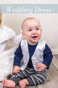 a baby sitting on the floor next to an adult