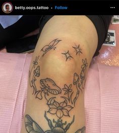 a woman's leg with tattoos on it