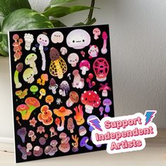 a card with stickers on it sitting next to a potted plant