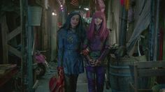 two women dressed in costumes standing next to each other