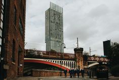 some people are standing in front of a bridge