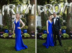 two people in formal wear standing next to each other on grass with large letters behind them