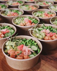 several bowls filled with different types of food on top of a wooden table next to each other