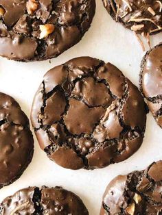 several chocolate cookies with nuts on top