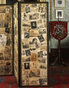 a man standing in front of a tall cabinet covered with pictures and photos on it