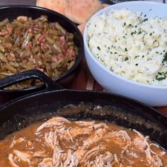 three different types of food in black pans next to each other on a table