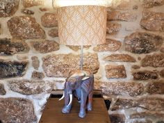 an elephant lamp sitting on top of a wooden table