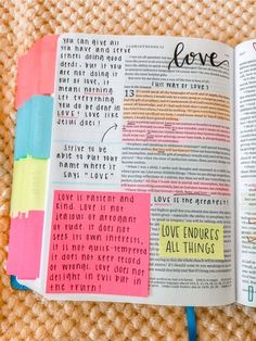 an open bible with colorful sticky notes on the pages and words written in different languages