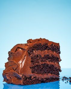 a piece of chocolate cake on a blue surface