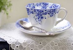 a cup and saucer with spoons on a table