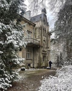 an old house with snow on the ground