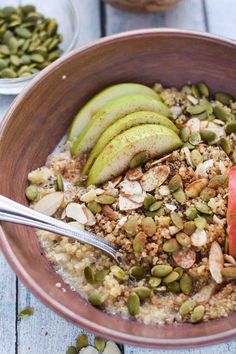 a bowl filled with oatmeal, apples and nuts