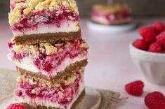 raspberry cheesecake bars stacked on top of each other