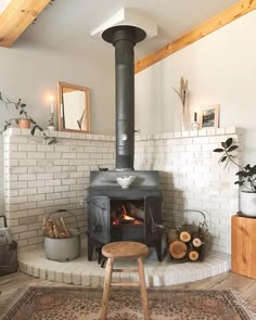 a living room with a fire place and rugs on the floor in front of it