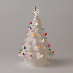 a white ceramic christmas tree with multicolored lights