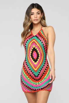 a woman wearing a colorful crochet dress