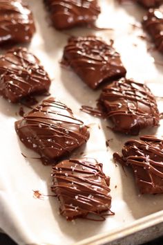 chocolate sea salt caramels on a baking sheet with the words milk chocolate sea salt caramels