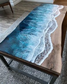 a coffee table with an ocean scene painted on it and the words instagram above it