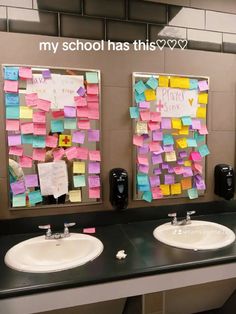 two sinks with post it notes attached to the wall above them in a public restroom