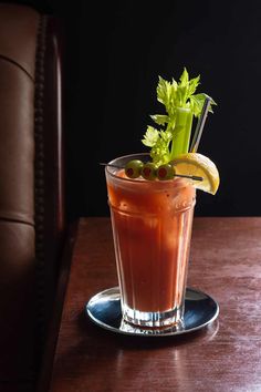 a drink with garnish on the rim sits on a table